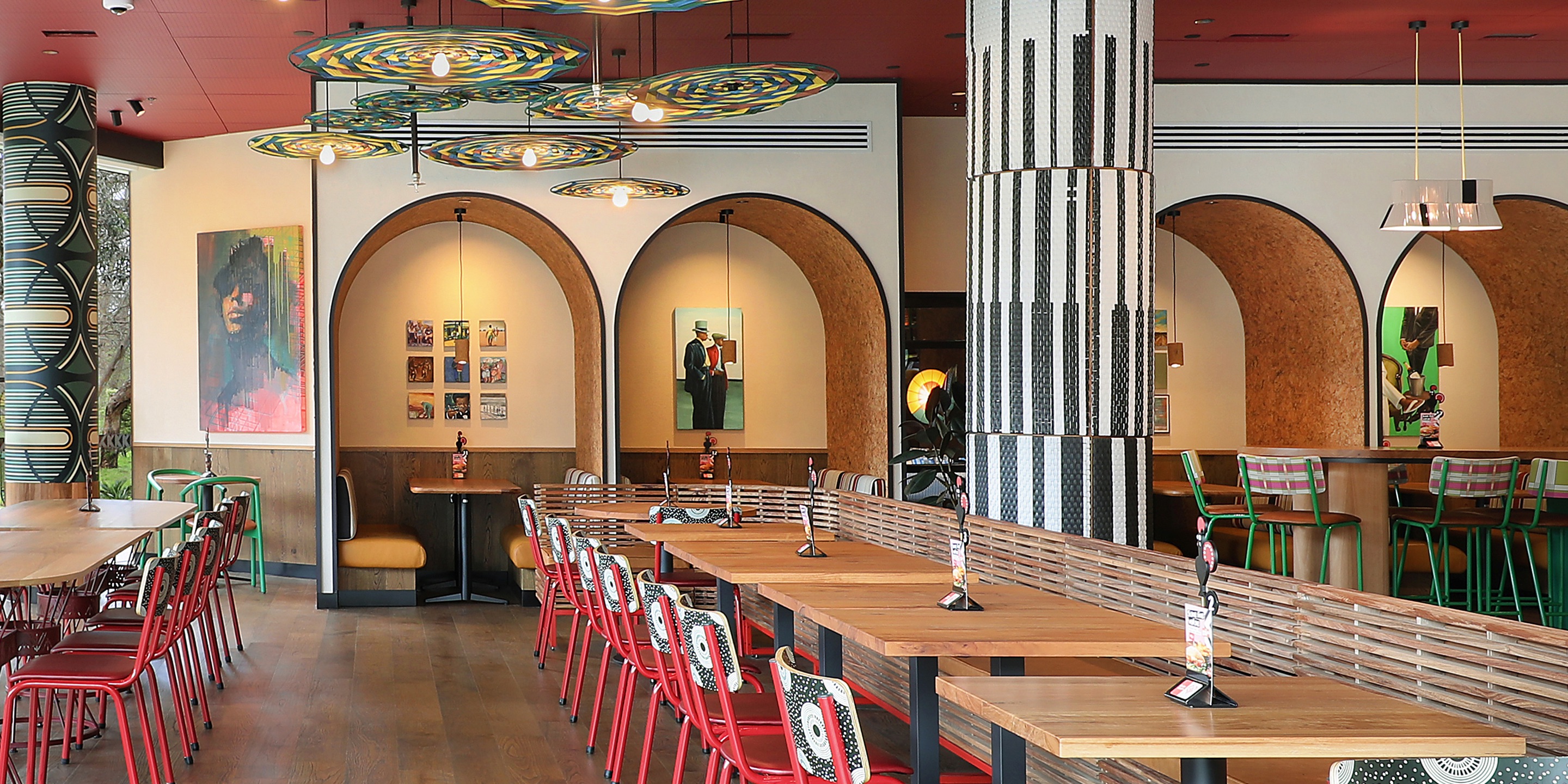 a Nando’s meal on a table including PERi-PERi chicken, a salad, chips, and a selection of sides